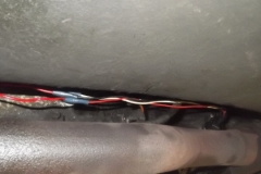 176 aftermarket wiring hanging from under the transmission near exhaust