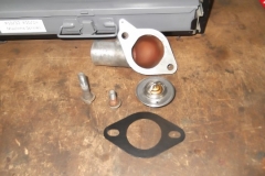 131 thermostat housing cleaned, smoothed, and ready to install with black painted gasket